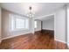 Sunlit dining room with hardwood floors, large window, and modern light fixture at 1251 Richland Sw Rd, Atlanta, GA 30310