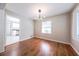 Open dining room with hardwood floors, a modern lighting fixture, leading to the kitchen at 1251 Richland Sw Rd, Atlanta, GA 30310