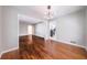 Dining room with hardwood floors and modern lighting fixture, flowing to the kitchen at 1251 Richland Sw Rd, Atlanta, GA 30310