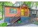 Charming home with wood siding, a bright yellow door, and updated landscaping for excellent curb appeal at 1251 Richland Sw Rd, Atlanta, GA 30310