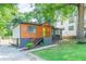 Well-maintained home with a two-tone exterior, yellow front door, and a landscaped yard with mature trees at 1251 Richland Sw Rd, Atlanta, GA 30310
