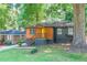 Charming home featuring a colorful front door, wood accents, and a well-maintained lawn with mature trees at 1251 Richland Sw Rd, Atlanta, GA 30310