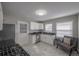 Well-lit kitchen featuring white cabinets, granite countertops, and modern appliances at 1251 Richland Sw Rd, Atlanta, GA 30310