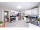 Clean, bright kitchen featuring white cabinets, modern appliances, and sleek countertops with a stainless steel sink at 1251 Richland Sw Rd, Atlanta, GA 30310