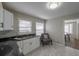 Well-lit kitchen featuring white cabinets, granite countertops, and modern appliances at 1251 Richland Sw Rd, Atlanta, GA 30310