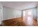 Open-concept living space featuring hardwood floors, neutral paint, and seamlessly transitions into a bright dining area at 1251 Richland Sw Rd, Atlanta, GA 30310