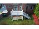 Brick house with a white deck featuring stairs down to a stone patio and green grass at 1711 Summit Glen Ln, Atlanta, GA 30329