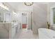 Bright bathroom showcasing marble tile, double vanity, soaking tub, and glass shower at 1711 Summit Glen Ln, Atlanta, GA 30329