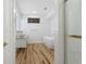 Modern bathroom featuring a soaking tub, dual vanities, and wood-style flooring at 1711 Summit Glen Ln, Atlanta, GA 30329