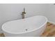 Modern freestanding bathtub with wooden floors and a chrome faucet at 1711 Summit Glen Ln, Atlanta, GA 30329