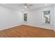 Bright bedroom features wood floors, neutral walls, white trim, and an updated ceiling fan at 1711 Summit Glen Ln, Atlanta, GA 30329