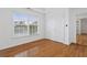 Bright bedroom featuring hardwood floors and a large window with backyard views at 1711 Summit Glen Ln, Atlanta, GA 30329