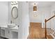 Bright foyer features hardwood floors, a modern light fixture, and a stylish powder room at 1711 Summit Glen Ln, Atlanta, GA 30329