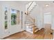 Bright foyer with hardwood floors, staircase, and white trim leads into the main living areas at 1711 Summit Glen Ln, Atlanta, GA 30329