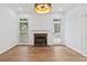 Bright living room features hardwood floors, a marble fireplace, and a stylish chandelier at 1711 Summit Glen Ln, Atlanta, GA 30329