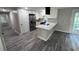 Kitchen featuring white cabinets, gray wood floors and stainless steel appliances at 3042 Humphries Hill Rd, Austell, GA 30106