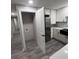 A view of the kitchen showcasing white cabinets, stainless appliances, and adjacent laundry area at 3042 Humphries Hill Rd, Austell, GA 30106