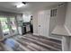 This bright kitchen features stainless steel appliances, and grey wood floors at 3042 Humphries Hill Rd, Austell, GA 30106