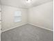 Bright bedroom with light grey carpet and a window provides natural light at 3282 Spicy Cedar Ln, Lithonia, GA 30038