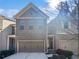 This brick and siding home features an attached two-car garage, tidy landscaping and a covered entry at 3282 Spicy Cedar Ln, Lithonia, GA 30038