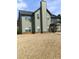 Backyard view featuring a two-story home with siding, a chimney, and a covered patio area at 8413 Members Dr, Jonesboro, GA 30236