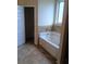 Bathroom featuring a soaking tub and tile surround at 8413 Members Dr, Jonesboro, GA 30236