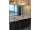 Bathroom with double vanity and soaking tub reflected in the large mirror at 8413 Members Dr, Jonesboro, GA 30236