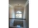 Hallway with chandelier and railing at 8413 Members Dr, Jonesboro, GA 30236