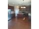 Kitchen featuring dark wood cabinetry, granite countertops, stainless steel appliances, and a center island at 8413 Members Dr, Jonesboro, GA 30236