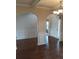 Spacious living room featuring archways, dark wood floors, and natural light at 8413 Members Dr, Jonesboro, GA 30236