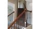 Beautiful staircase with wood railing and wrought iron spindles at 8413 Members Dr, Jonesboro, GA 30236