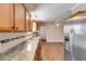 Bright kitchen with stainless steel appliances, granite countertops, and wood cabinets at 4094 Yancey Rd, Douglasville, GA 30135