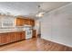 Functional kitchen with wood cabinets, white appliances, and ample counter space at 4094 Yancey Rd, Douglasville, GA 30135