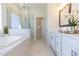 Luxurious bathroom with a soaking tub, glass-enclosed shower, and marble accents at 504 Healy Dr # 75, Cumming, GA 30040