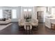 Open-concept dining room with modern chandelier, neutral chairs, and elegant decor at 504 Healy Dr # 75, Cumming, GA 30040
