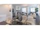 Open floor plan: dining room and living room featuring modern decor and ample natural light at 504 Healy Dr # 75, Cumming, GA 30040