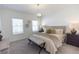 Cozy main bedroom with neutral tones, large windows, and a brick accent wall at 504 Healy Dr # 75, Cumming, GA 30040