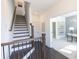 Elegant staircase featuring dark wood treads, white risers, and modern metal railings at 504 Healy Dr # 75, Cumming, GA 30040