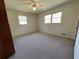 Neutral bedroom with carpet, natural light from windows, and a ceiling fan at 719 Copper Trace Way, Woodstock, GA 30189