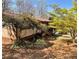 Charming home exterior with colorful flowering bushes and mature trees, creating a welcoming atmosphere at 719 Copper Trace Way, Woodstock, GA 30189