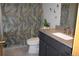 Stylishly updated bathroom with a modern vanity and a shower with a decorative leafy curtain at 1302 Buttercup Ct, Lawrenceville, GA 30044