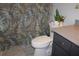 Bathroom featuring a toilet and vanity with a sink, complemented by a leafy shower curtain at 1302 Buttercup Ct, Lawrenceville, GA 30044