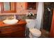 Cozy bathroom featuring a wood vanity, toilet, and walk-in shower, offering essential amenities at 1302 Buttercup Ct, Lawrenceville, GA 30044