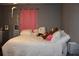 Cozy bedroom featuring grey walls, a full bed, and natural light from a nearby window at 1302 Buttercup Ct, Lawrenceville, GA 30044