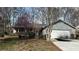 Charming one-story home featuring an attached garage and a well-maintained front yard with flowering trees at 1302 Buttercup Ct, Lawrenceville, GA 30044