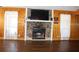 Comfortable living room featuring a stone fireplace, hardwood floors, and decorative accents at 1302 Buttercup Ct, Lawrenceville, GA 30044