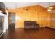 Spacious living room with wood paneling, a stone fireplace, and hardwood floors at 1302 Buttercup Ct, Lawrenceville, GA 30044