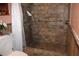 Spacious walk-in shower with tiled walls, grab bar, and a shower head for added convenience at 1302 Buttercup Ct, Lawrenceville, GA 30044