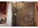 Accessible walk-in shower with tiled walls, grab bar, and adjustable shower head for comfort at 1302 Buttercup Ct, Lawrenceville, GA 30044