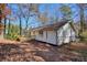 A home's backyard featuring a wooden deck and mature trees at 3310 Bryan Way, Marietta, GA 30008